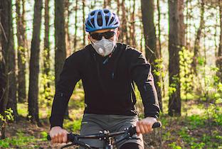 Mountain Biker wearing a helmet and mask