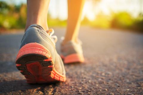 Image of person's feet walking down the street. 